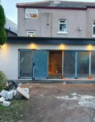 Rear extension under construction in Liverpool showing new bifold doors and rendered exterior walls
