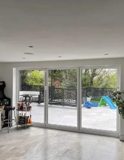 Garden room extension in Liverpool with white-framed bifold doors opening onto a paved patio