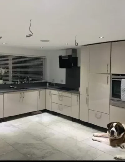 Fitted kitchen in Liverpool with high-gloss taupe cabinetry and dark worktops