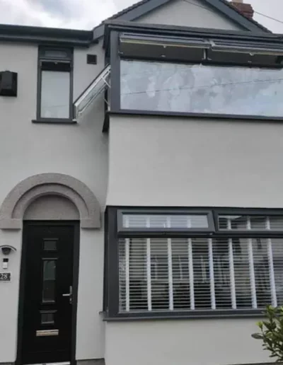 Completed house exterior in Liverpool with a rendered finish and glazed loft conversion dormer window
